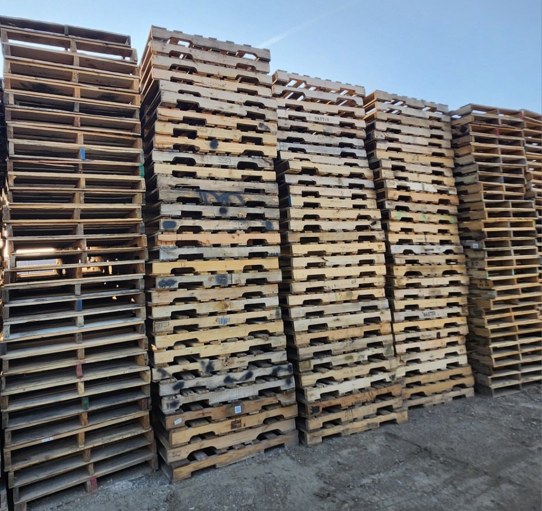 Stack of recycled 48x40 wooden pallets ready for shipping
